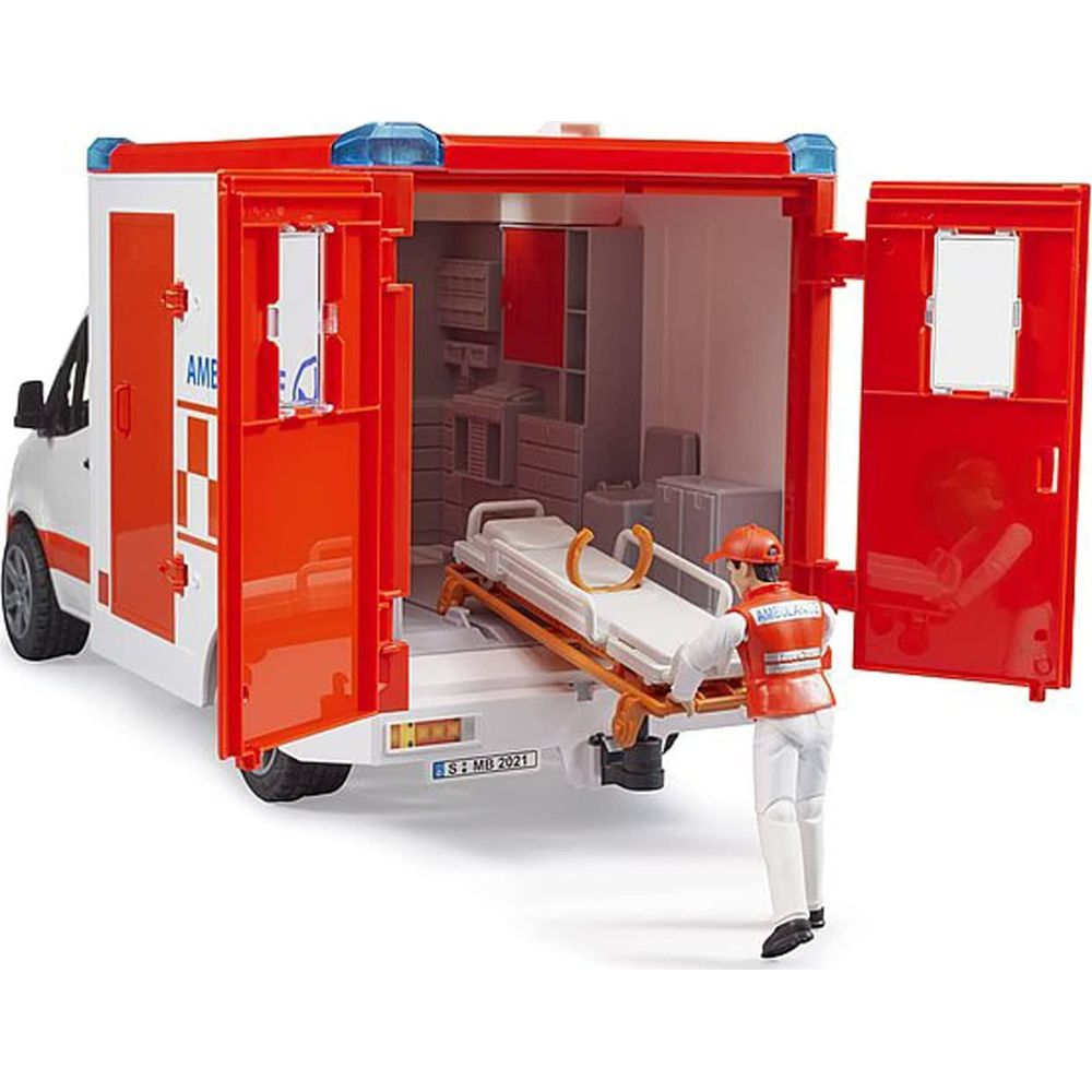 Ein Spielzeug-Rettungswagen mit geöffneten Türen, ein Tragebett wird herausgezogen.