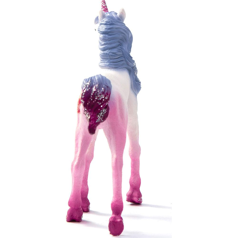 Różowy jednorożec z niebieskimi włosami i brokatem na ogonie.