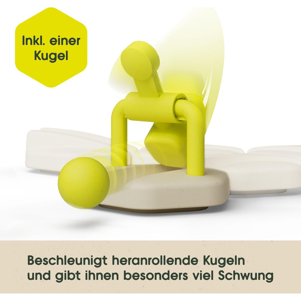 Ein gelber Ball rollt über eine beige Rampe mit einer gelben Vorrichtung.
