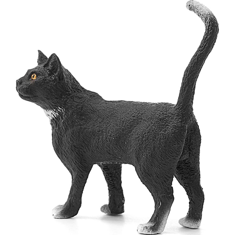 Figurine de chat noir aux yeux jaunes et au bout de queue blanc.