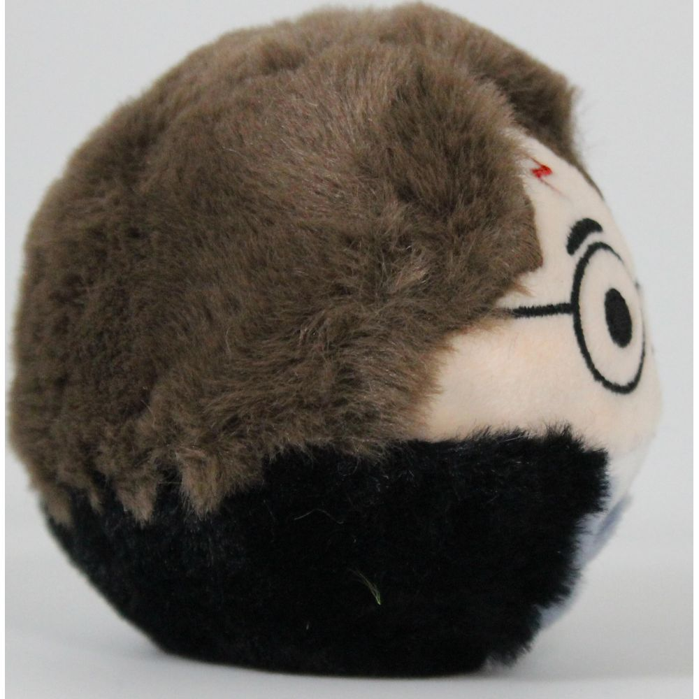 Ein runder Plüschball mit braunem Haar und Brille.