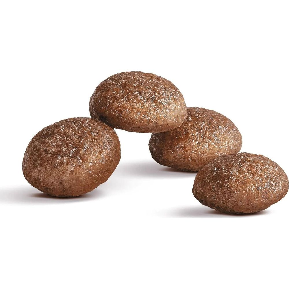 Cztery okrągłe, brązowe granulki na białym tle.