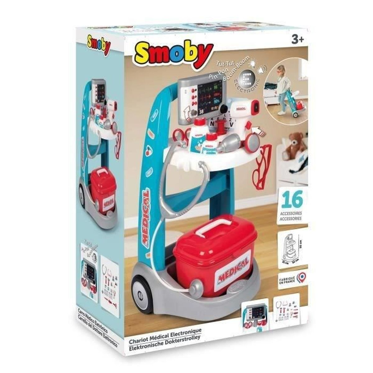 Un carrito médico azul y gris con equipo médico de juguete, estetoscopio y maletín rojo.