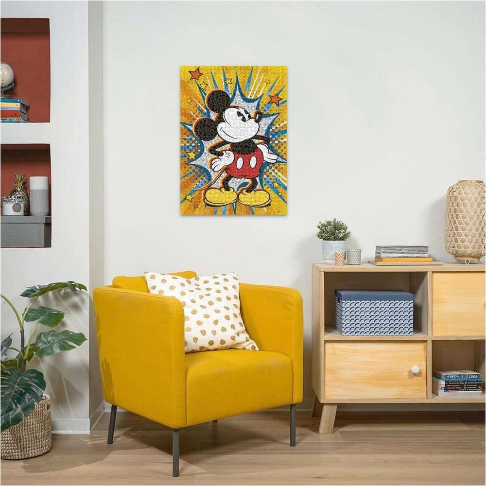 Un puzzle di Topolino con sfondo a fumetti è appeso sopra una poltrona gialla.