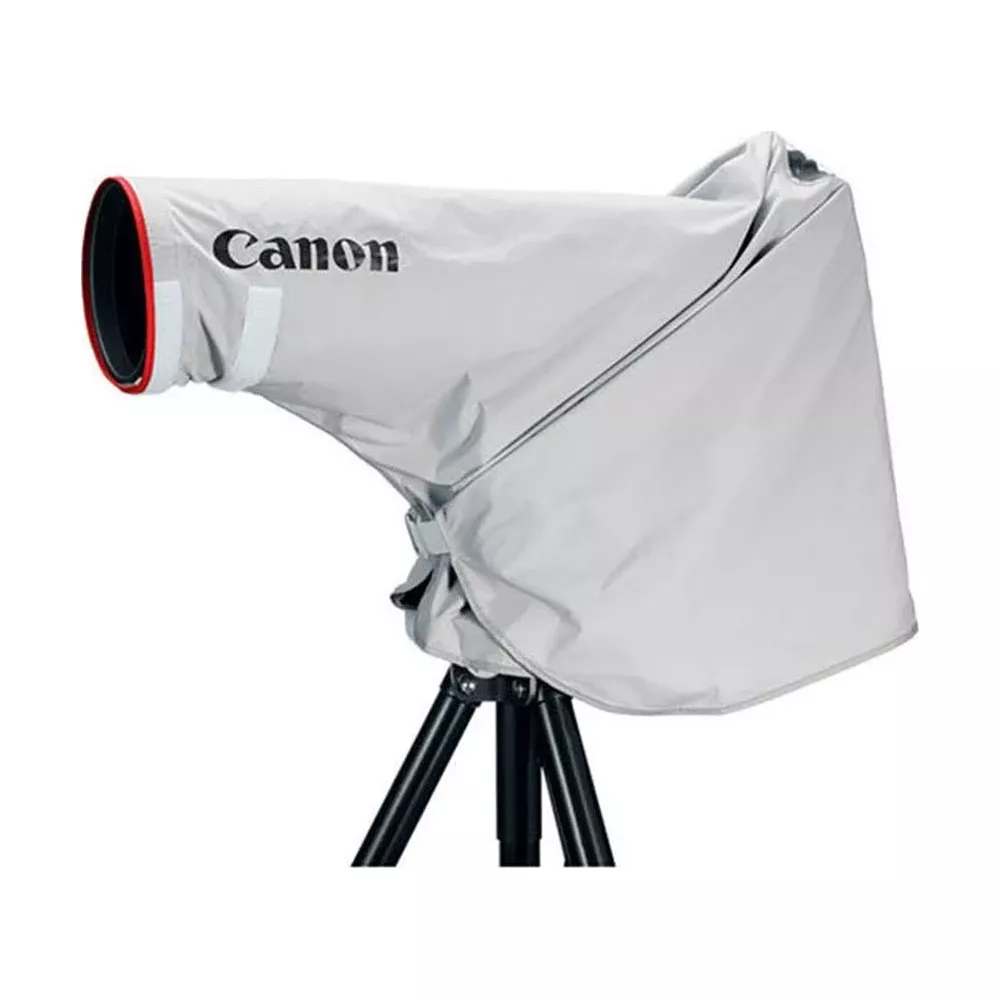 Copertura grigia per obiettivo Canon su treppiede. Bordo rosso e nero sull'obiettivo.