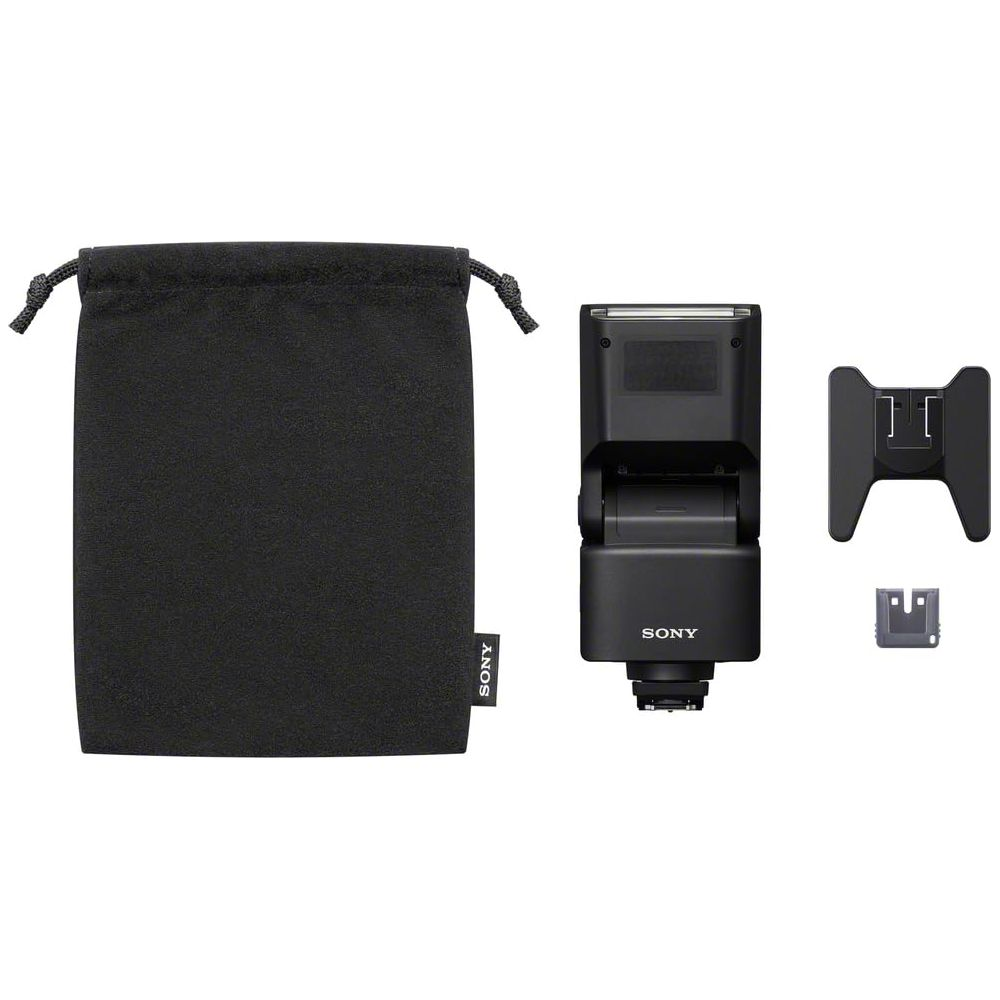 Borsa per fotocamera nera, unità flash e due supporti su sfondo bianco.