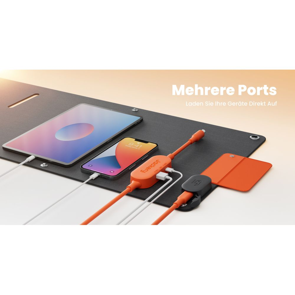 Ein Tablet und Smartphone laden auf einer Matte mit einem orangefarbenen Ladegerät.