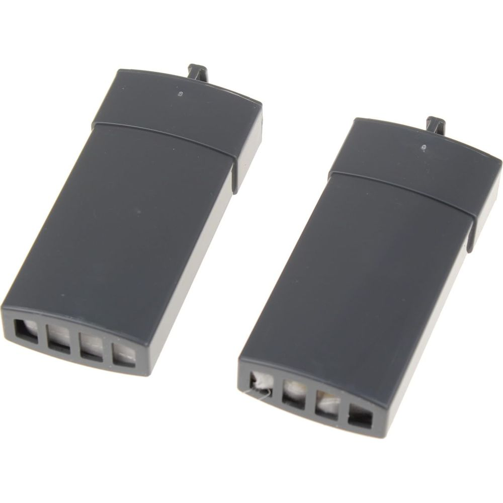 Dwa ciemnoszare prostokątne obiekty obok siebie, z otworami wentylacyjnymi.