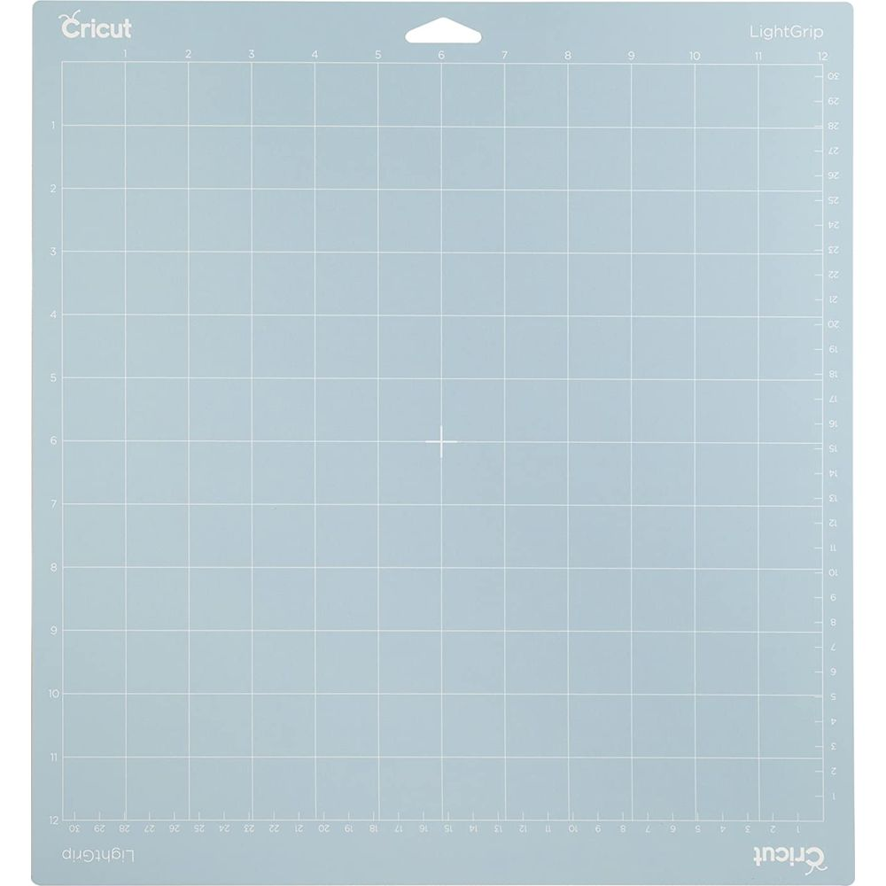 Eine blau-graue Schneidematte mit einem Gittermuster und Markierungen.