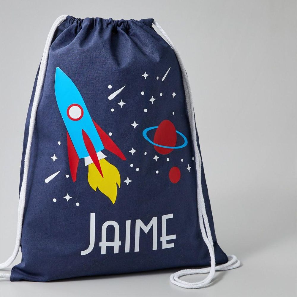 Dunkelblauer Rucksack mit Raketen- und Planetenmotiv und dem Namen JAIME.