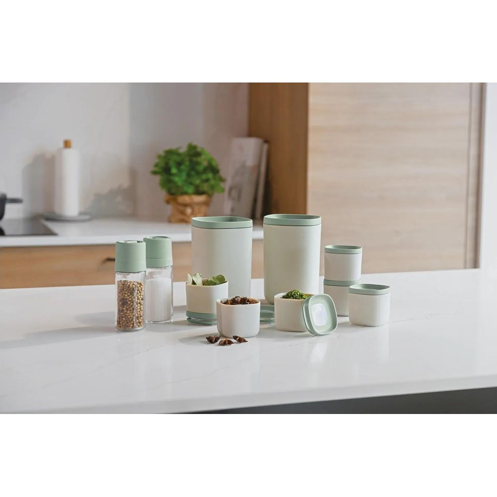 A collection of pastel kitchen containers with green accents.