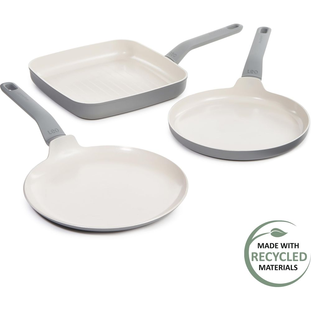 Three white and gray pans, one is a grill pan. Made with recycled materials logo.