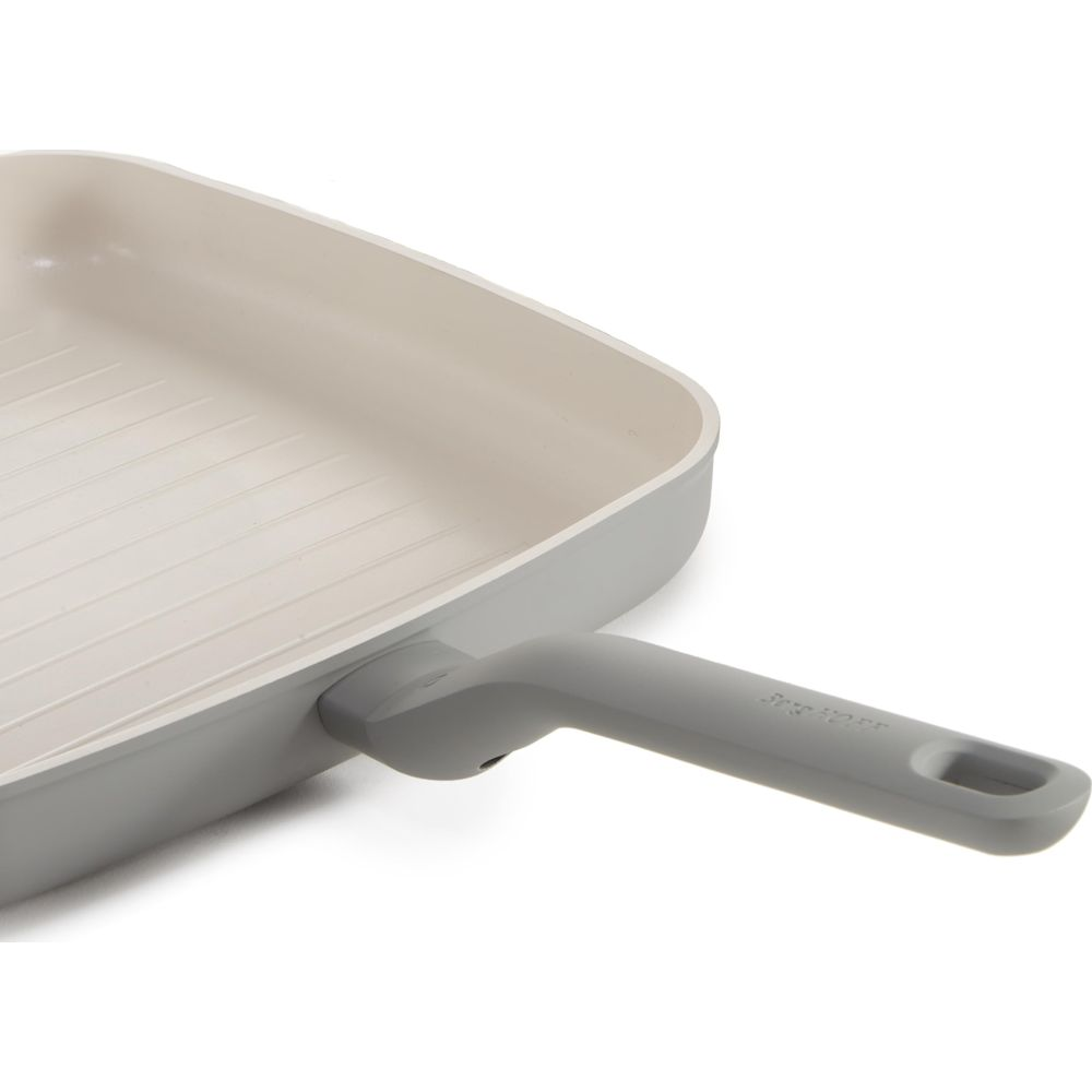 Gray grill pan with ribbed interior and gray handle.