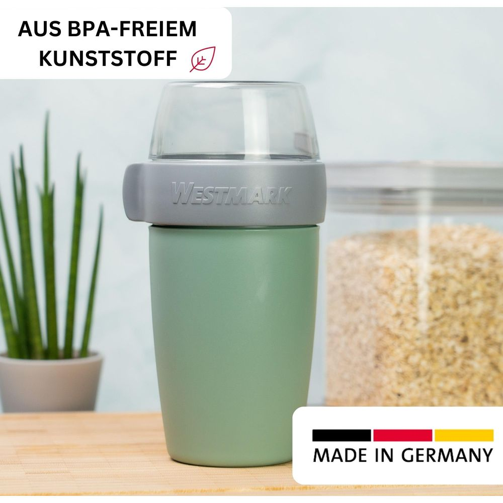 Grüne Westmark Aufbewahrungsdose mit transparentem Deckel, daneben ein Glas mit Getreide.