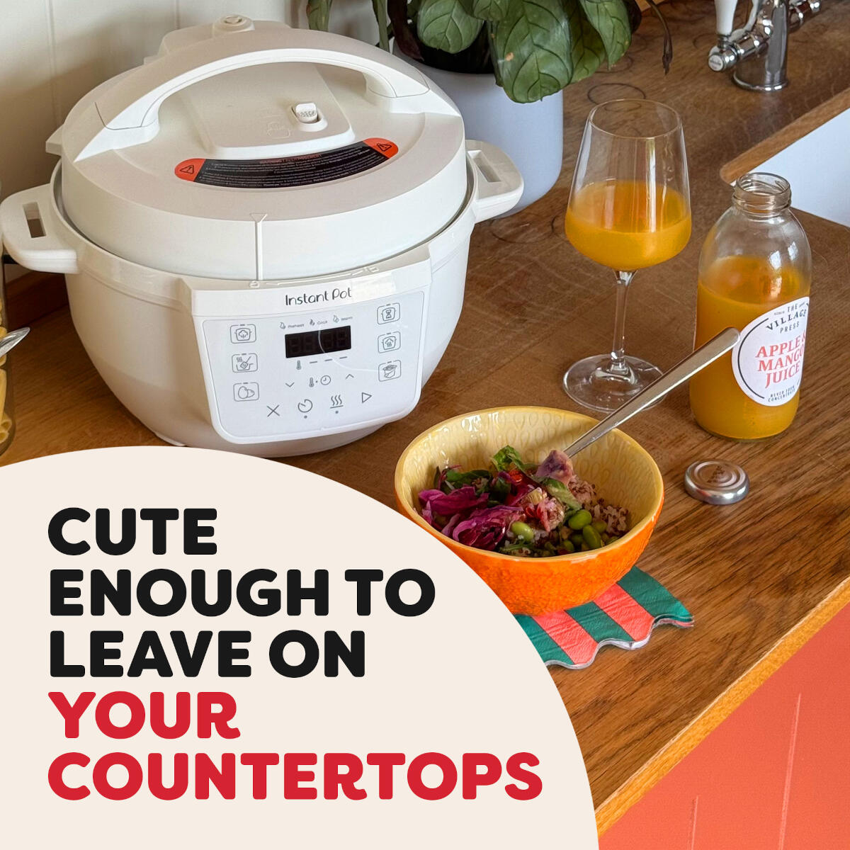 White Instant Pot on counter with bowl of food, glass of juice, and bottle of juice.