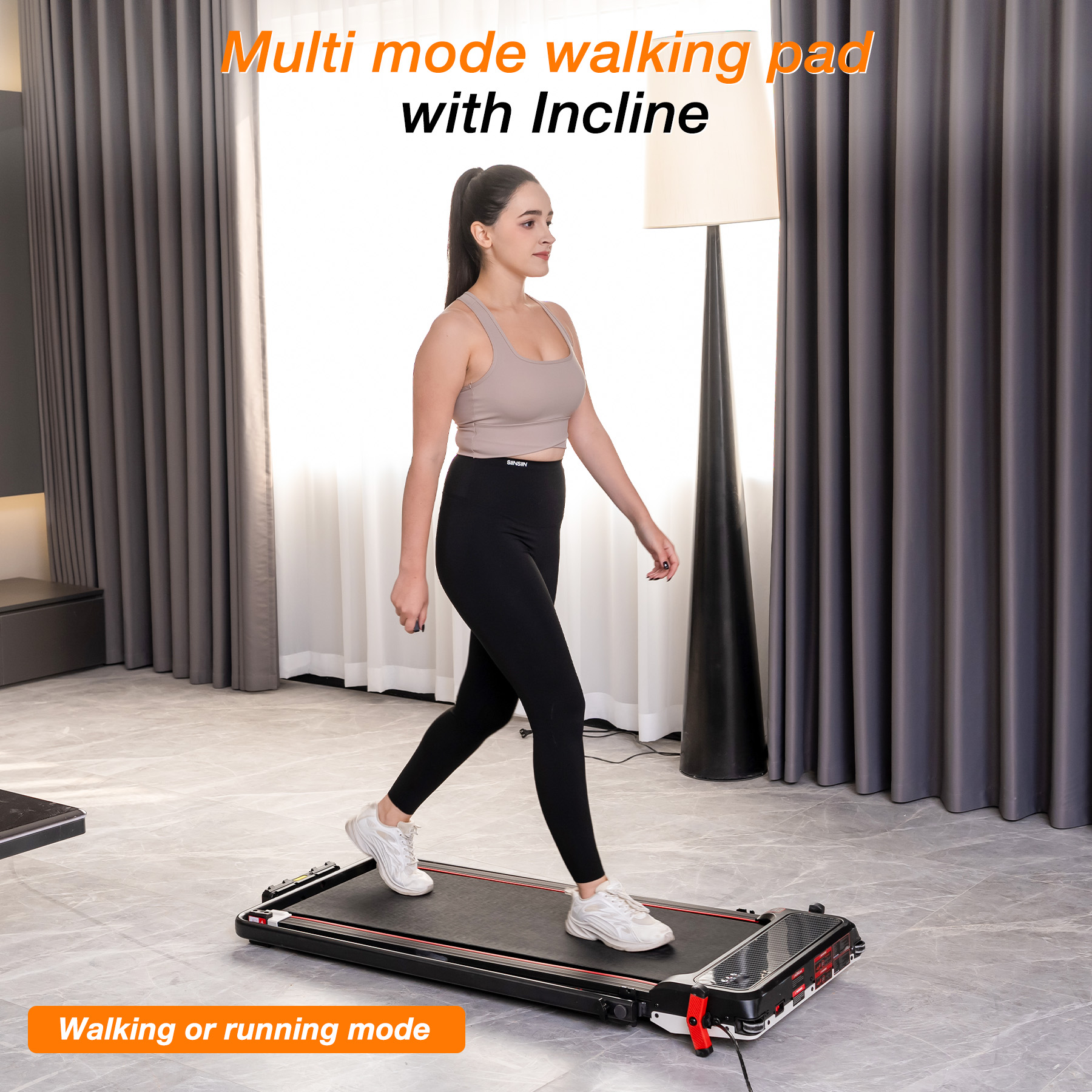 A woman in athletic wear walks on a slim treadmill in a modern room.