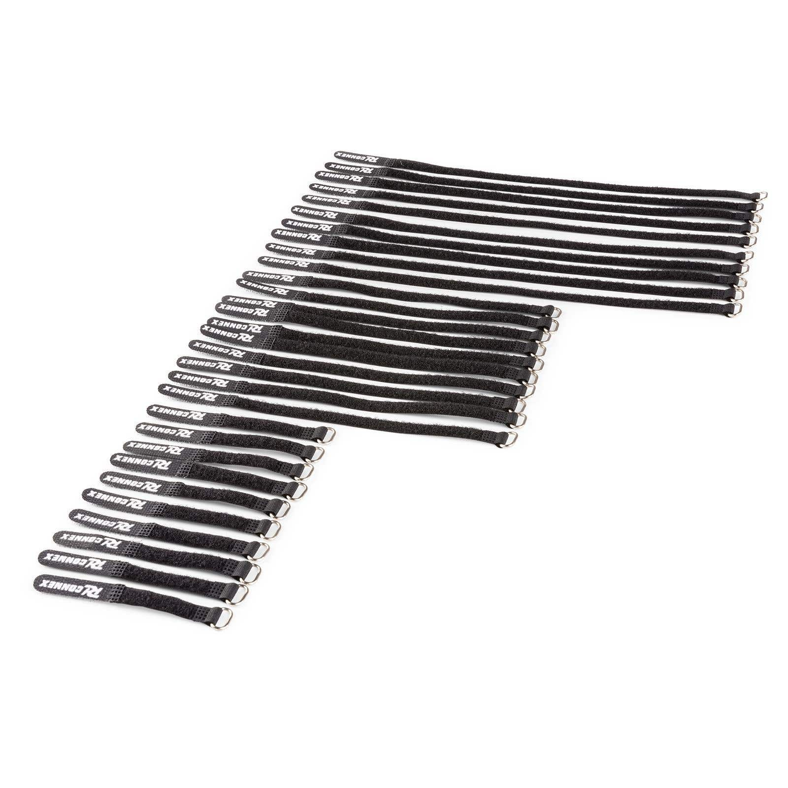 Varias correas de velcro negras con anillos plateados sobre fondo blanco.