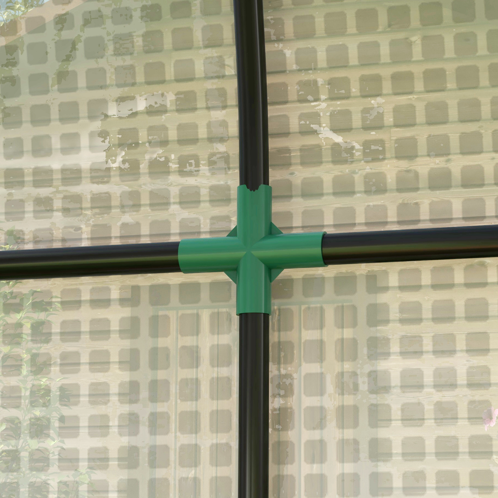 Tubos negros conectados por un conector cruzado verde.