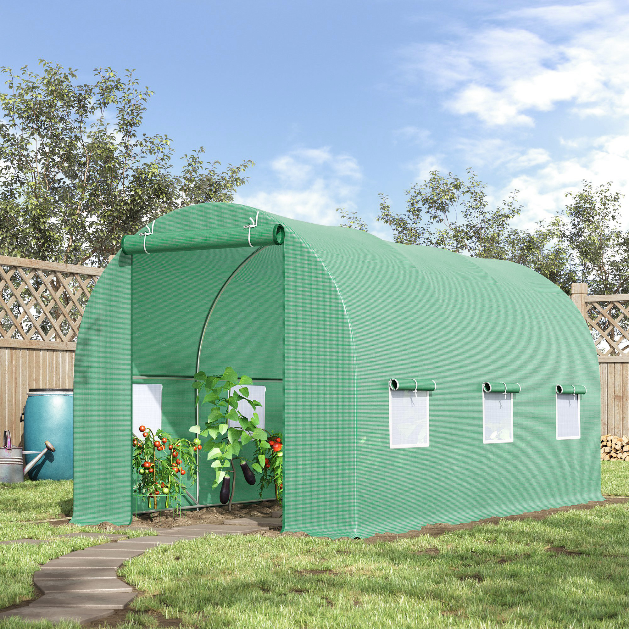 Un invernadero verde con tomates y berenjenas en un jardín.