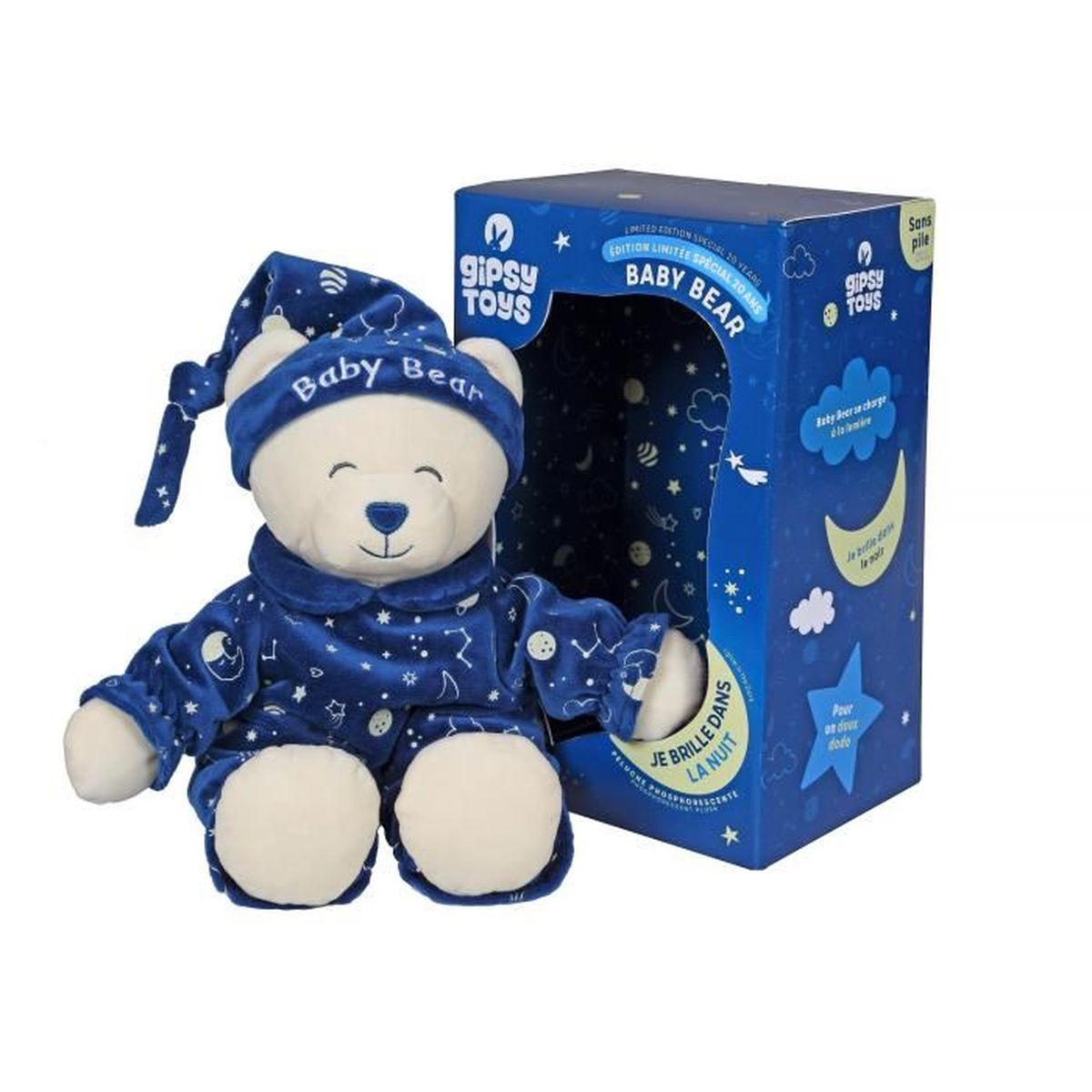 Un ours en peluche en pyjama et bonnet à côté d'une boîte. Avec étoiles et lunes.