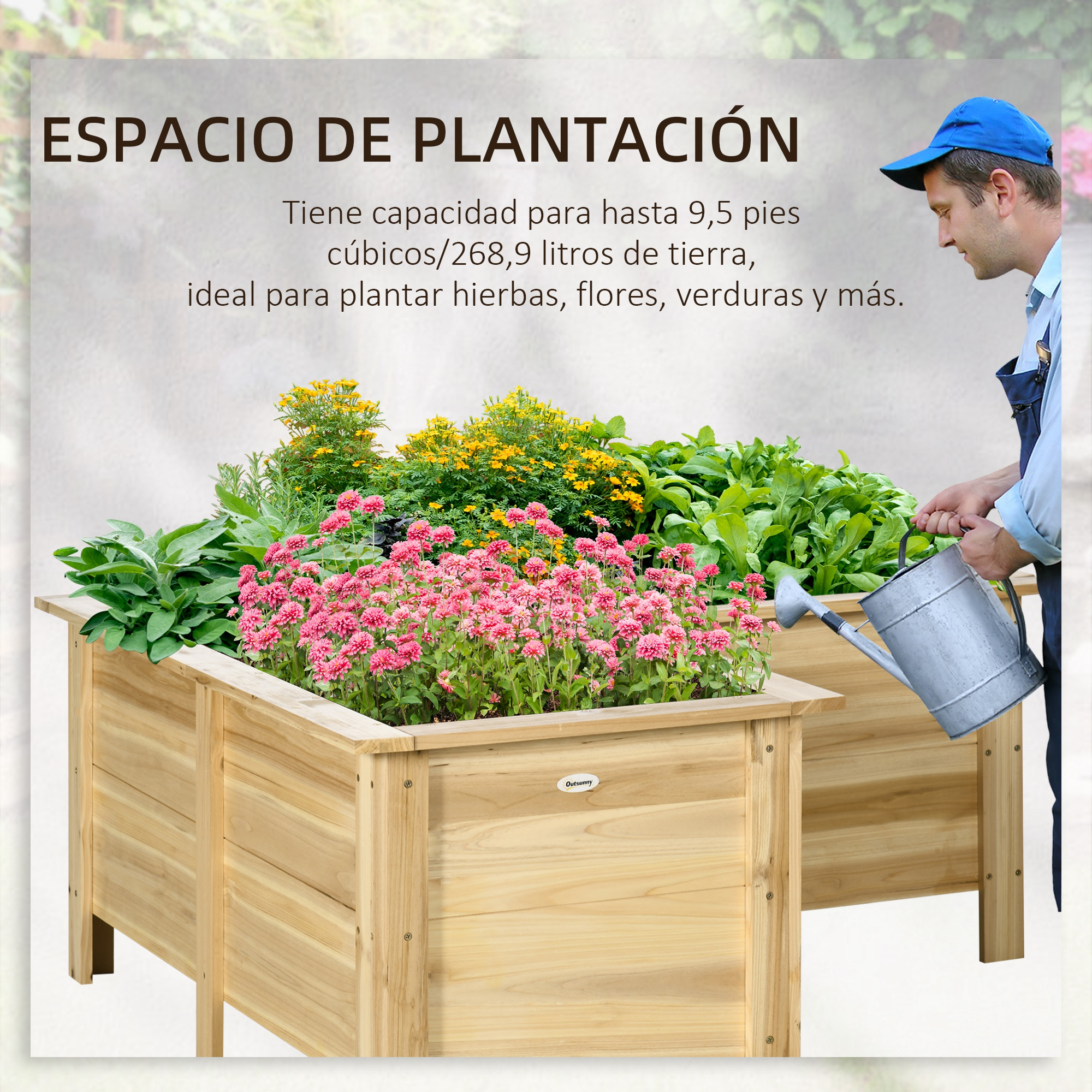 Un hombre con overol azul riega un bancal elevado con flores rosas y amarillas y plantas verdes.