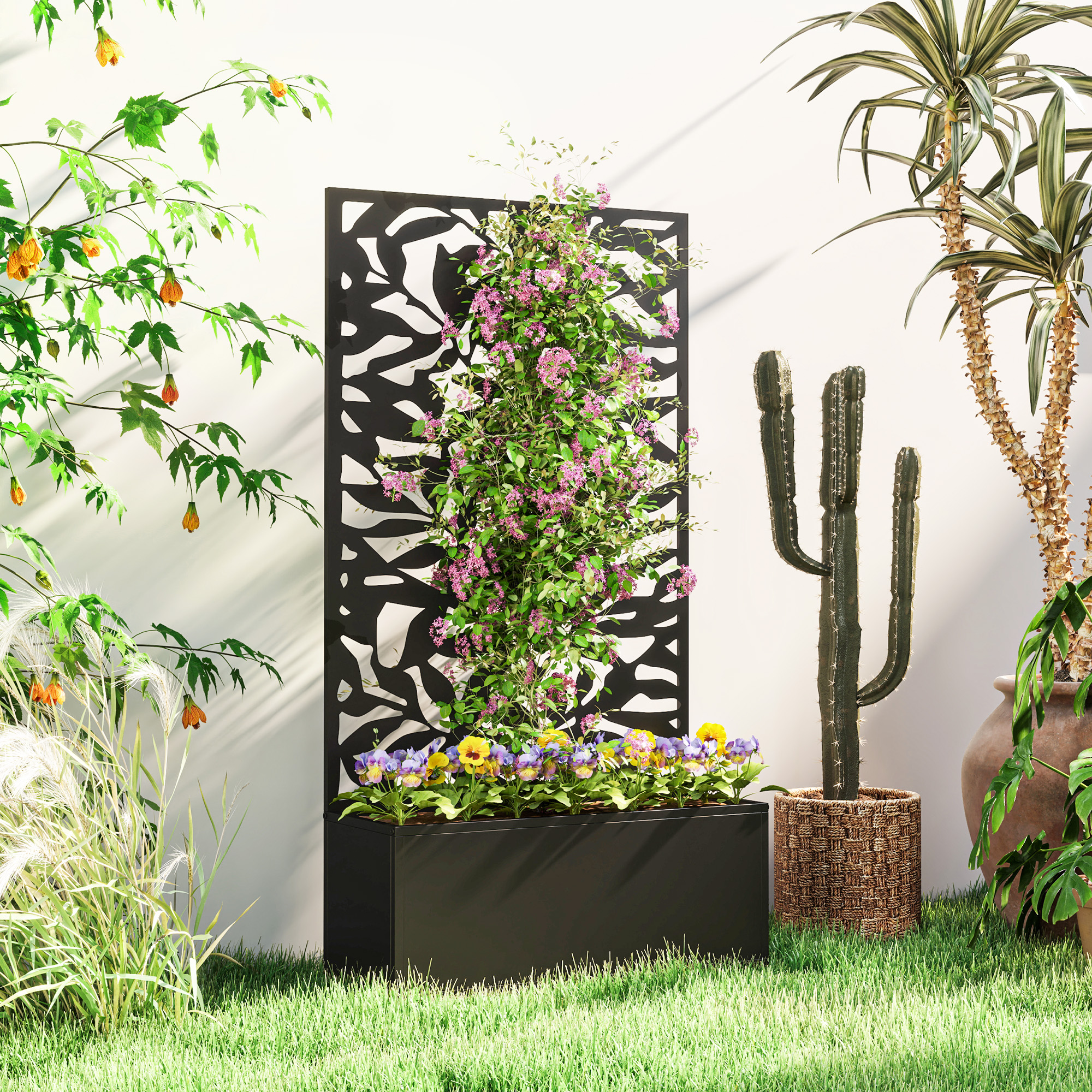 Una jardinera rectangular negra con pensamientos coloridos, al lado de un cactus.
