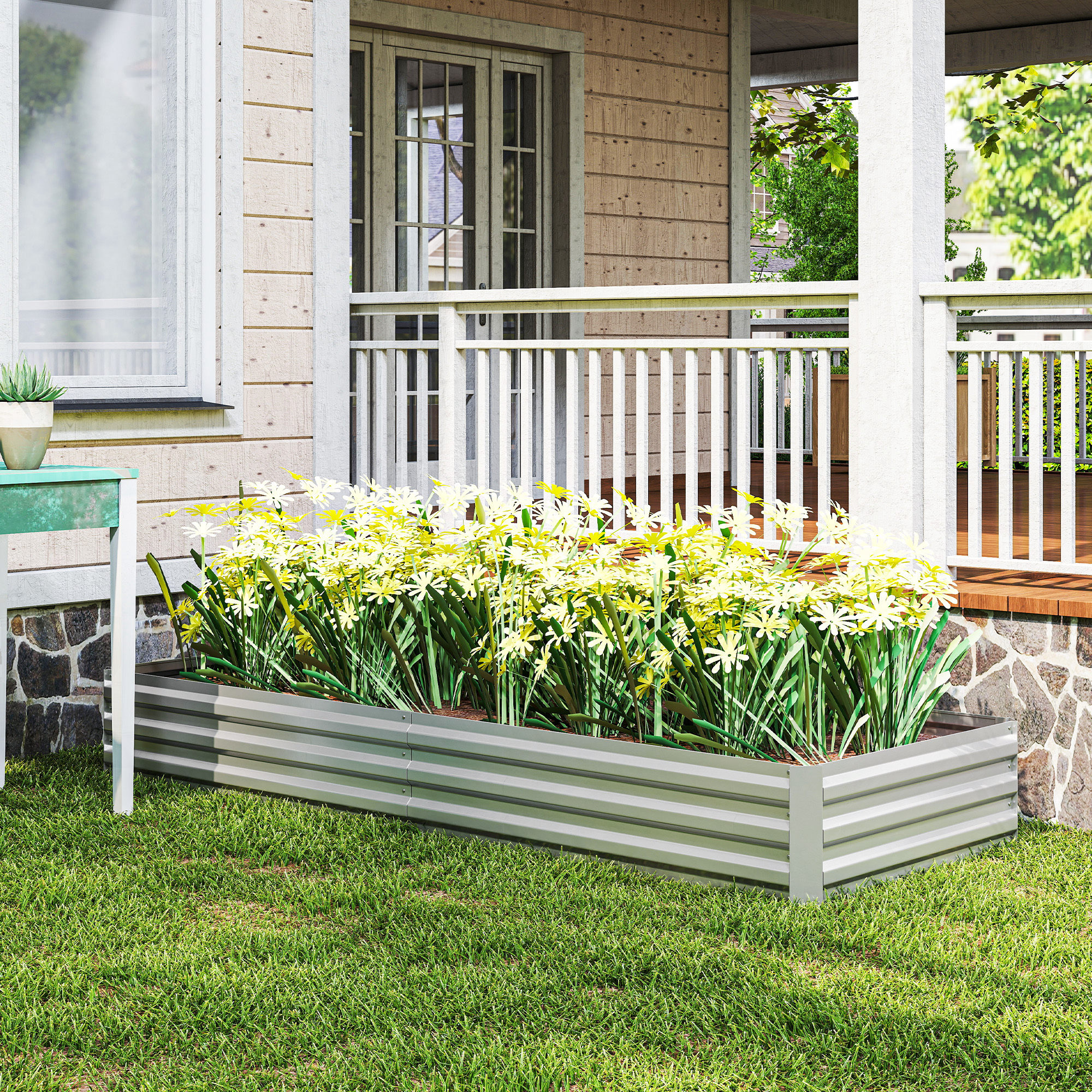 Un bancal elevado rectangular con flores amarillas frente a una casa con porche.