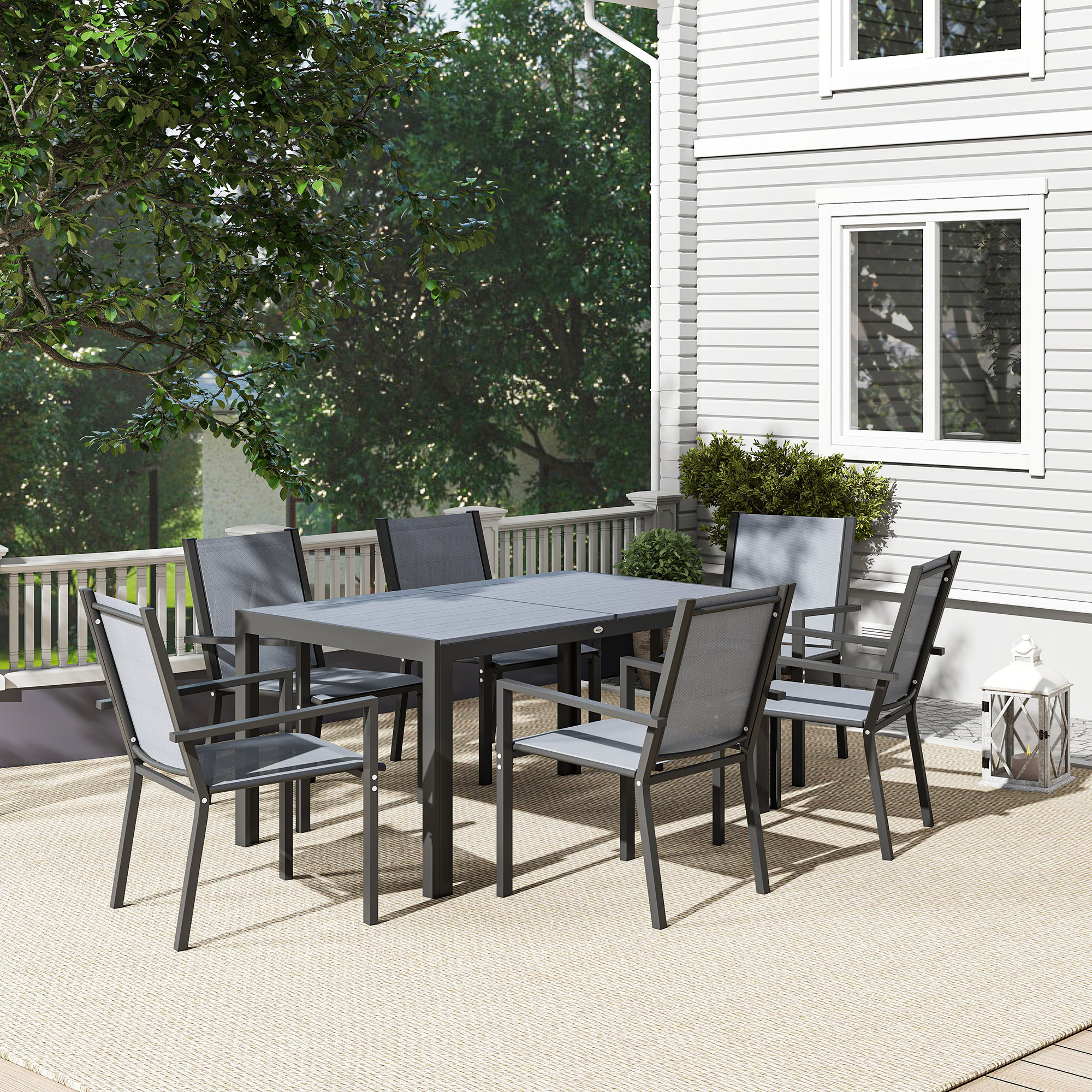 Una mesa de comedor gris con seis sillas en un patio con árboles.