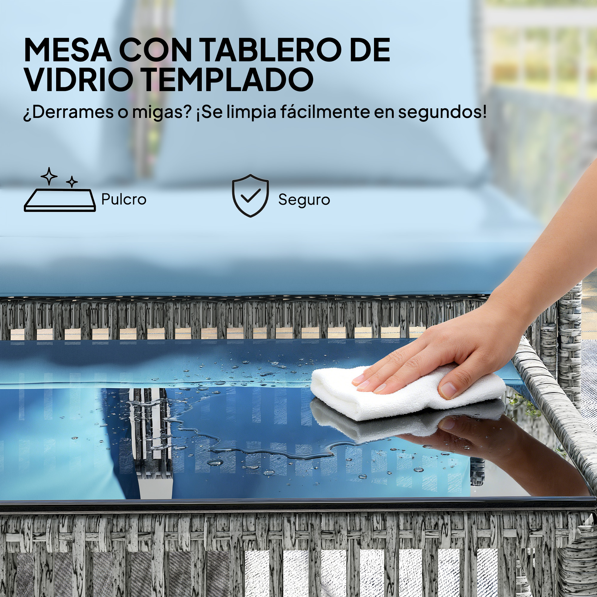 Una mano limpia un tablero de vidrio con un paño blanco.