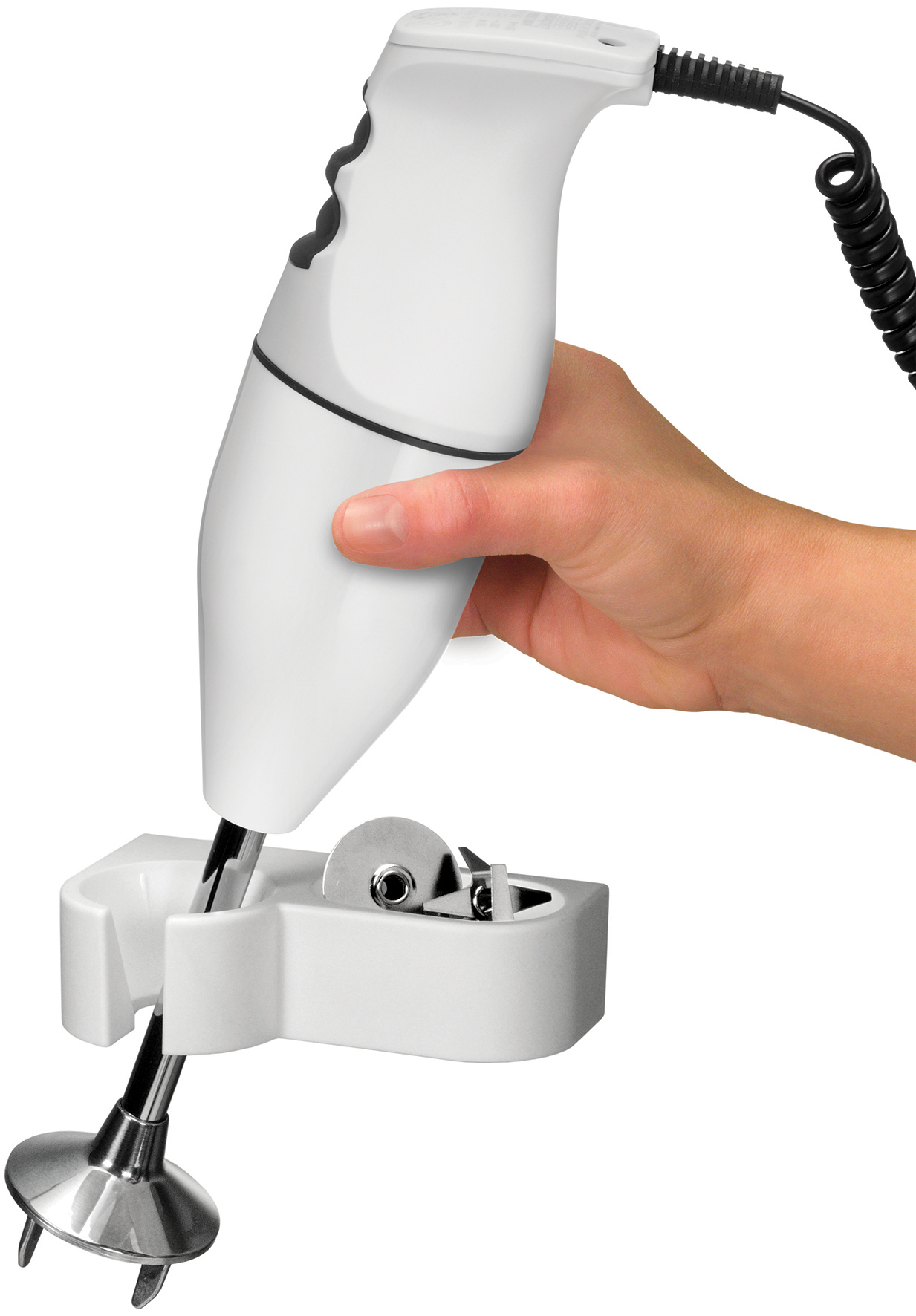 Eine Hand hält einen weißen Stabmixer, der in einer Halterung mit Klinge steckt.