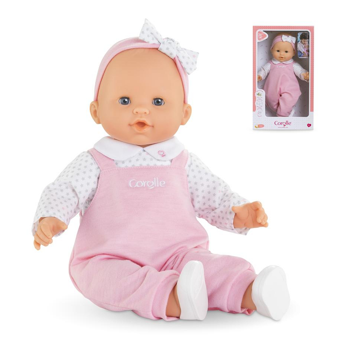 Eine Babypuppe in rosa Latzhose und Sternen-Shirt sitzt.
