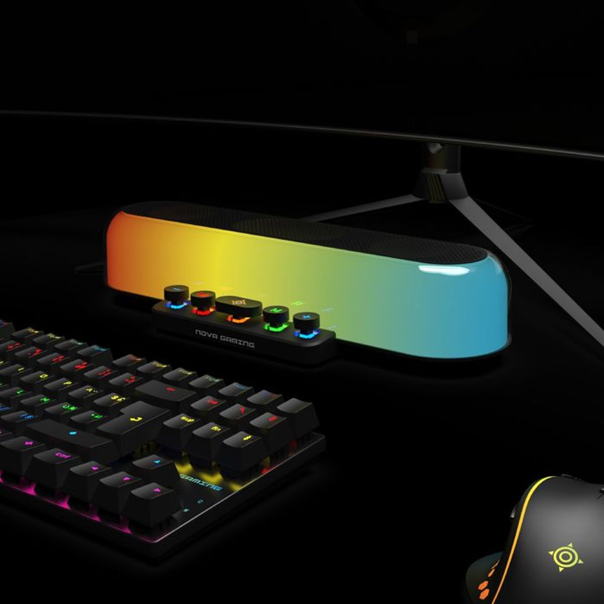 Eine Gaming-Tastatur, ein Controller und ein Monitor mit RGB-Beleuchtung auf einem schwarzen Schreibtisch.