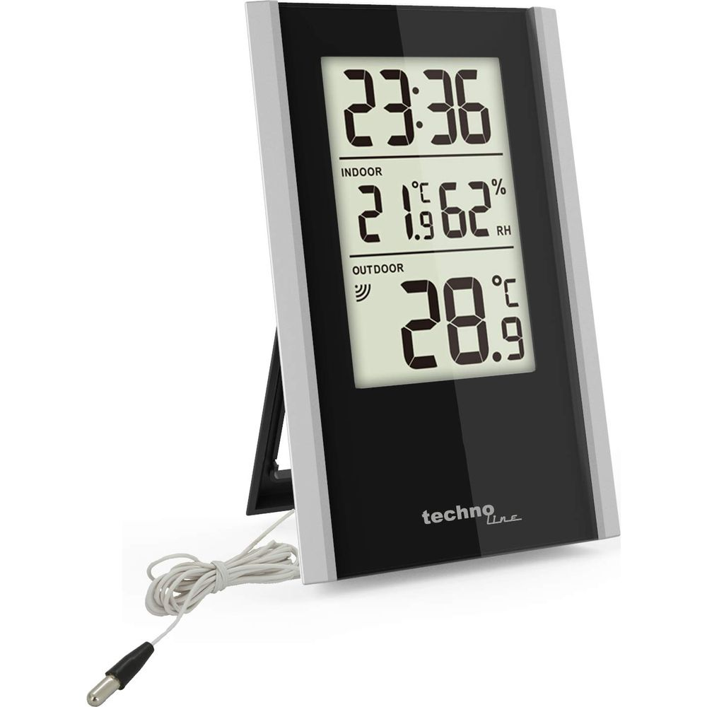 Un thermomètre numérique noir avec cordon blanc affiche 23h36, 21C intérieur, 28.9C extérieur.