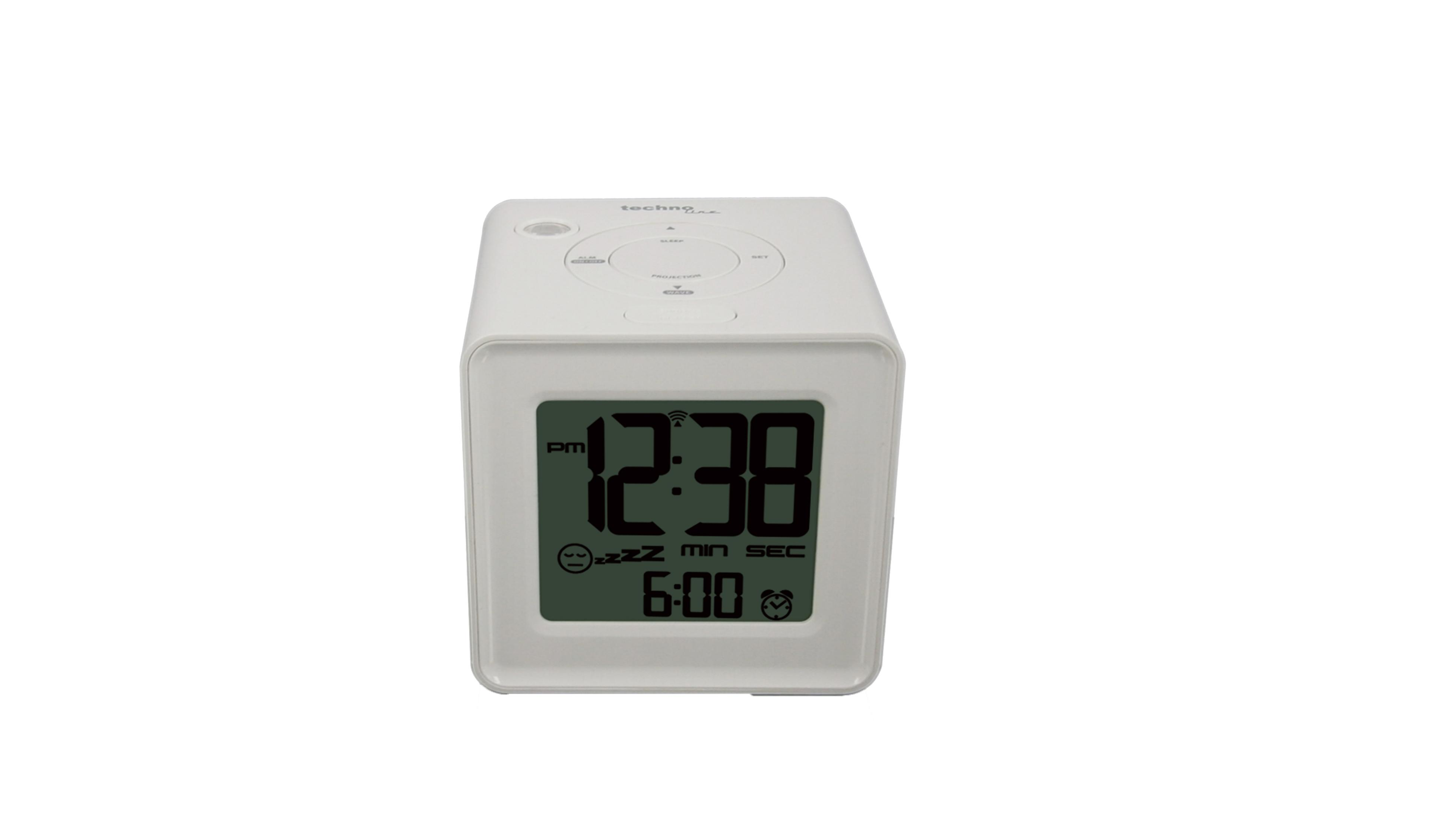 Un réveil numérique cube blanc avec écran vert affiche 12:38 et 6:00.