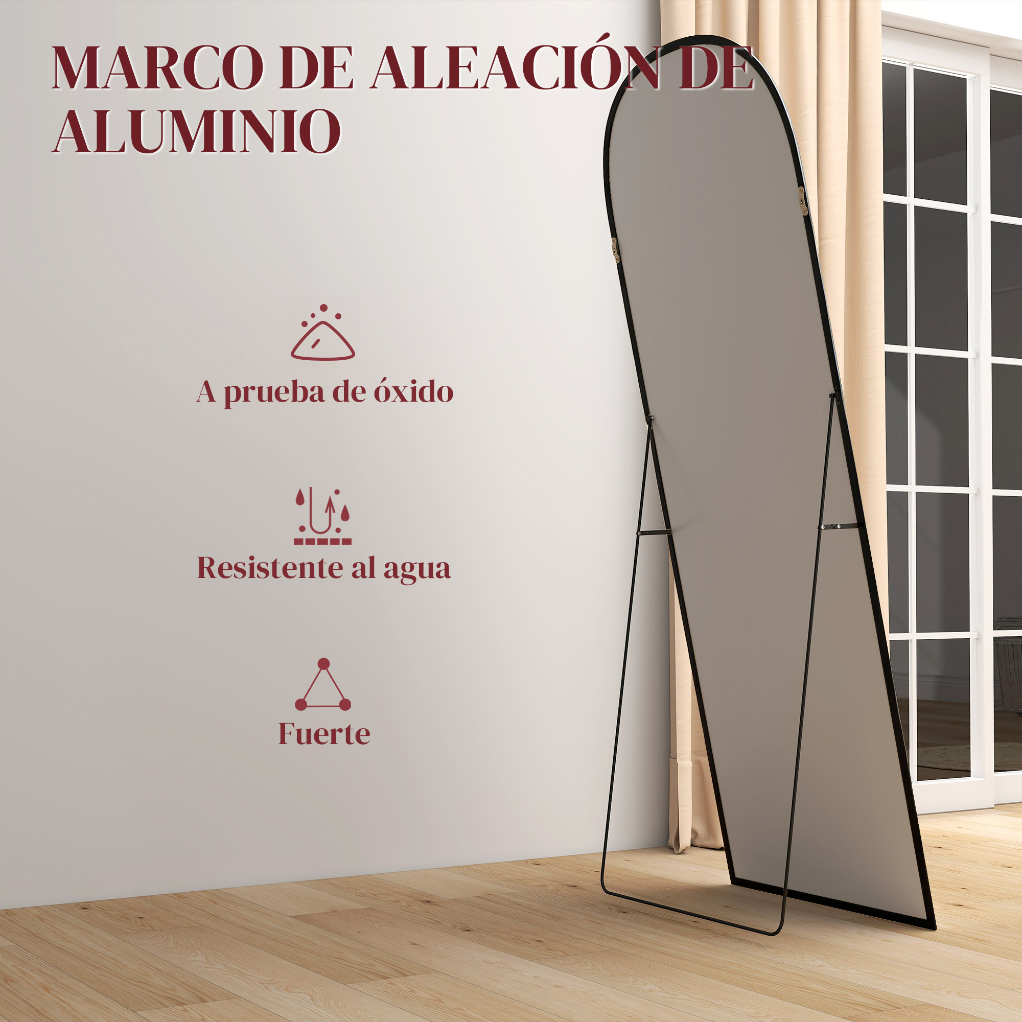 Un espejo de cuerpo entero con marco de aluminio sobre suelo de madera.
