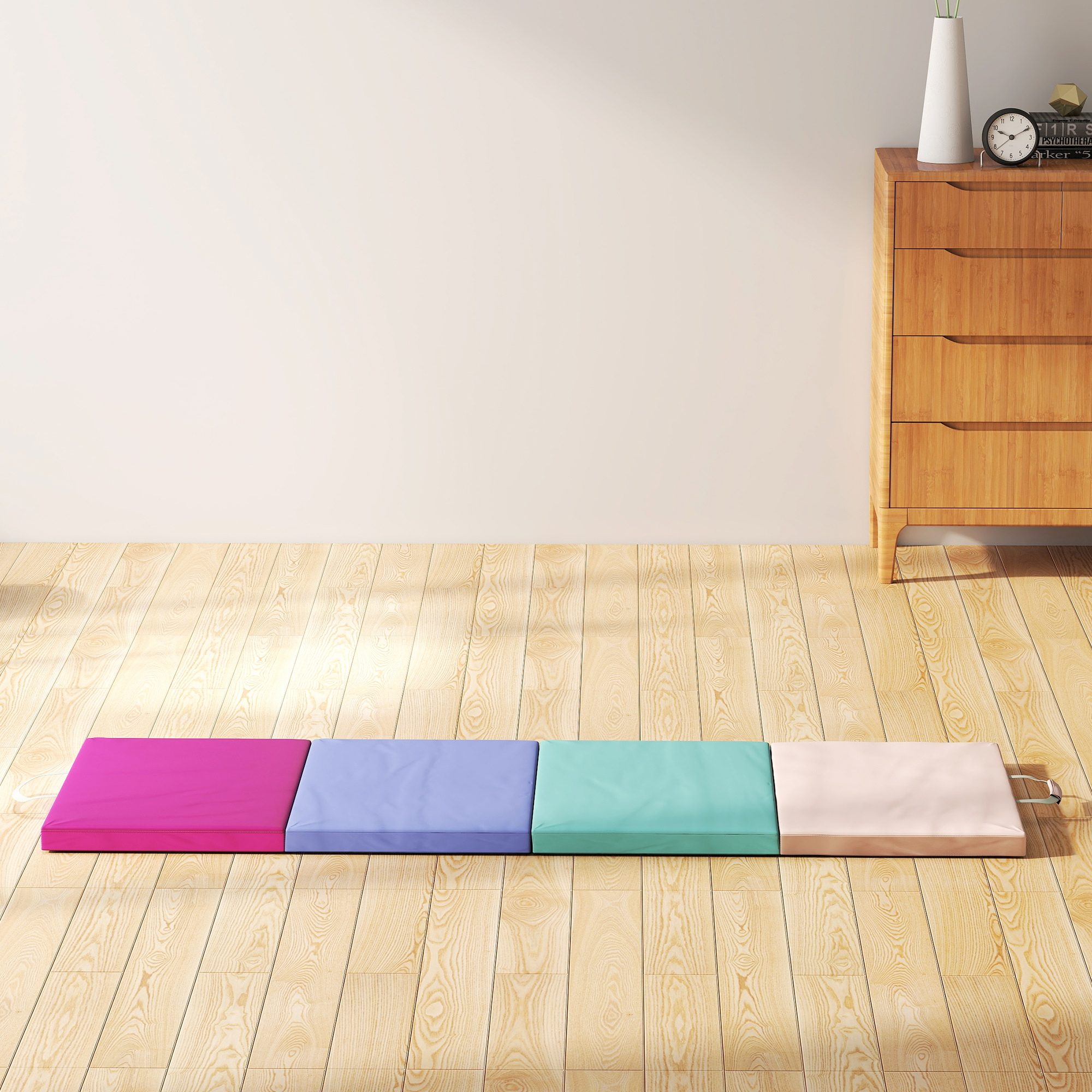 Cinco alfombras de suelo coloridas: rosa, azul, turquesa y crema.