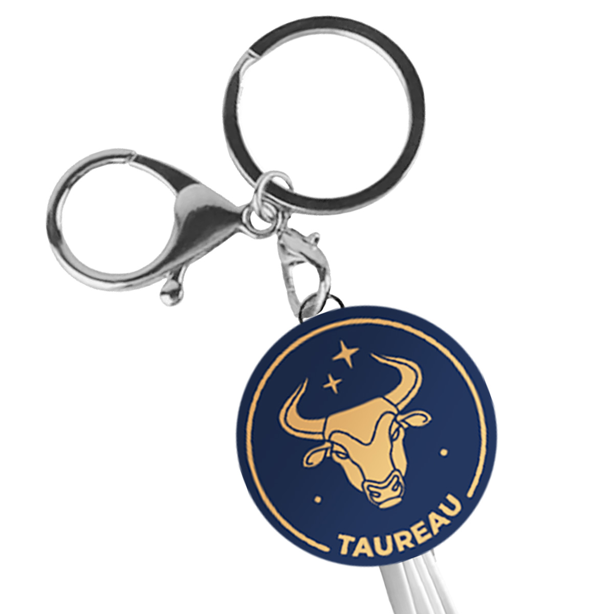Un portachiavi con simbolo di toro e la parola "TAUREAU" su sfondo blu scuro.