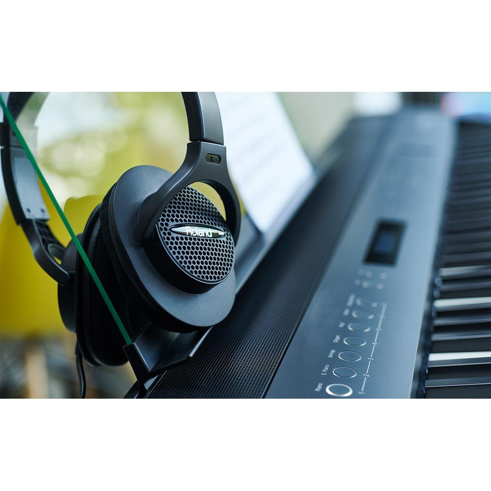Casque noir posé sur un clavier de piano noir.