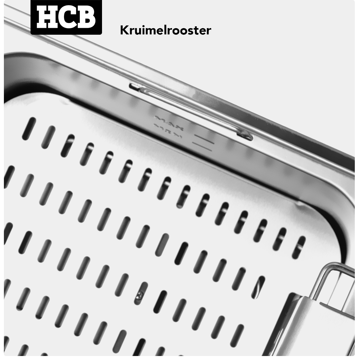 Close-up of a perforated metal tray with MAX marking and HCB logo.