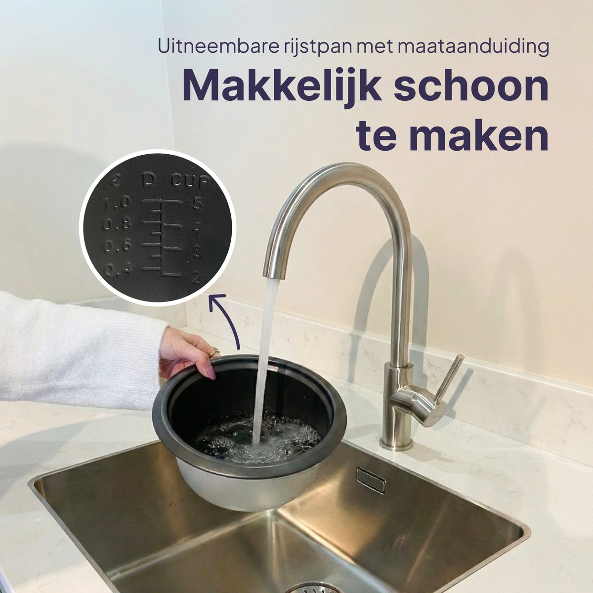 A rice cooker inner pot is rinsed under running water in a sink.