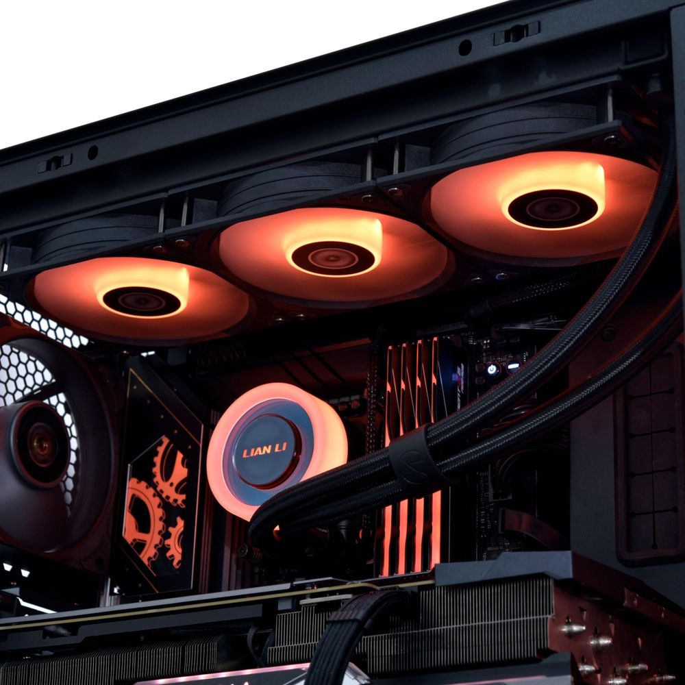 Ein PC-Gehäuse mit mehreren orange leuchtenden Lüftern und Wasserkühlung.