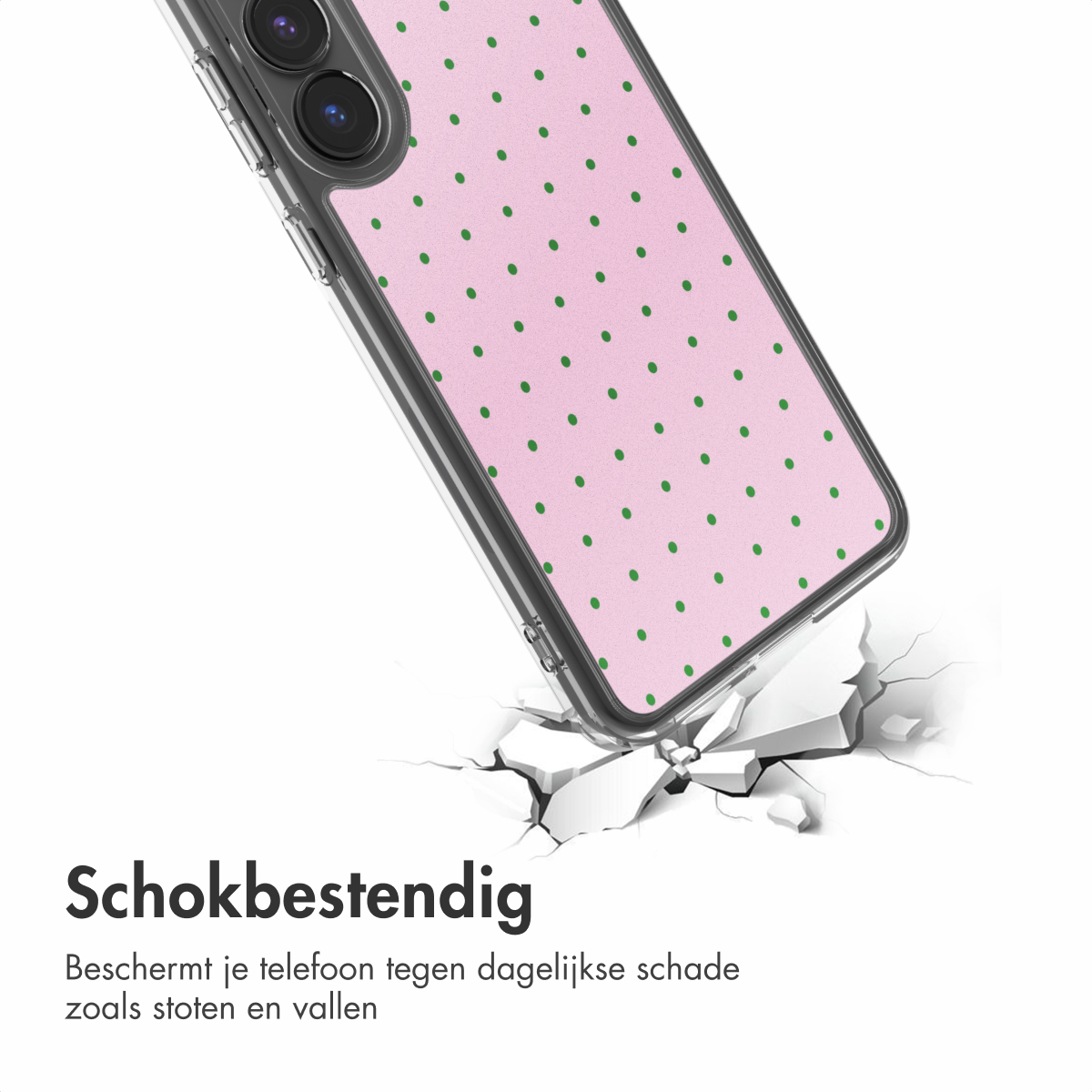 Roze telefoonhoesje met groene stippen valt en breekt grond.