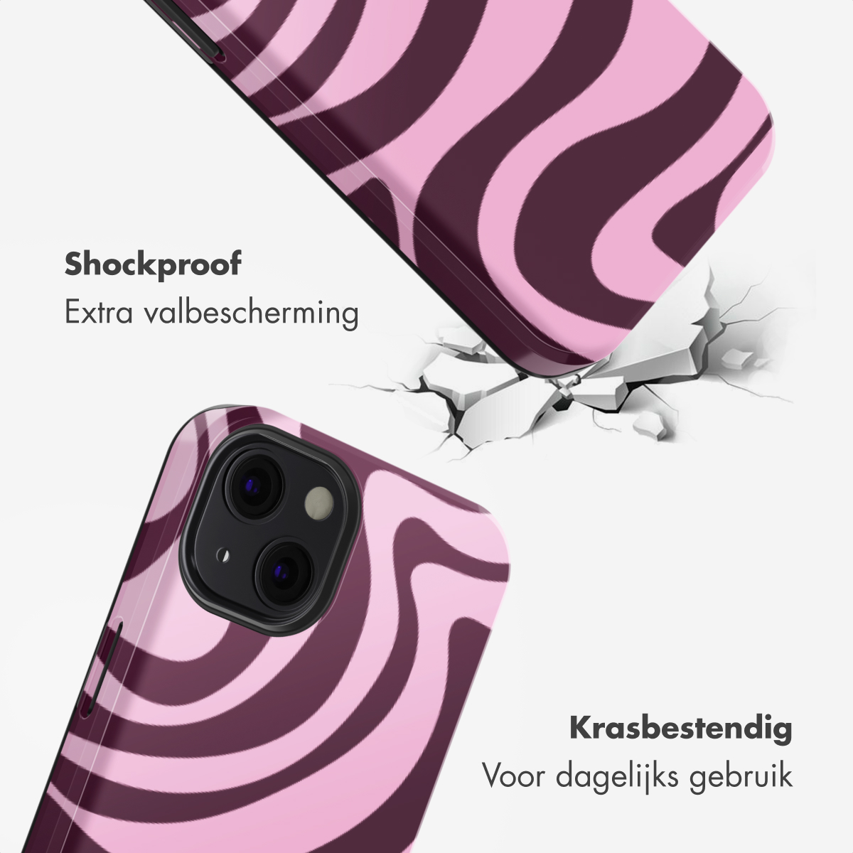 Paarse en roze telefoonhoes met golvend patroon valt op gebarsten grond.