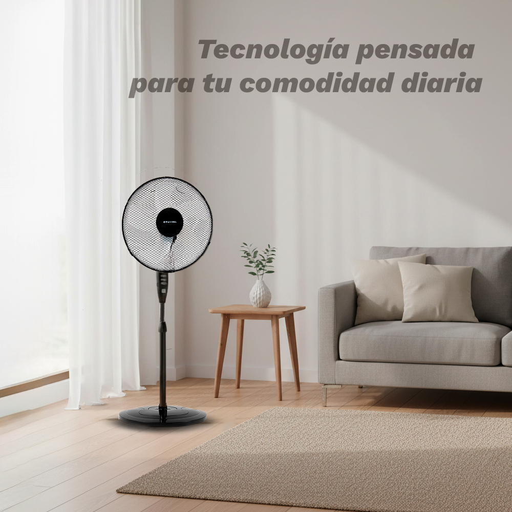 Un ventilador de pie negro está en un salón luminoso junto a un sofá.