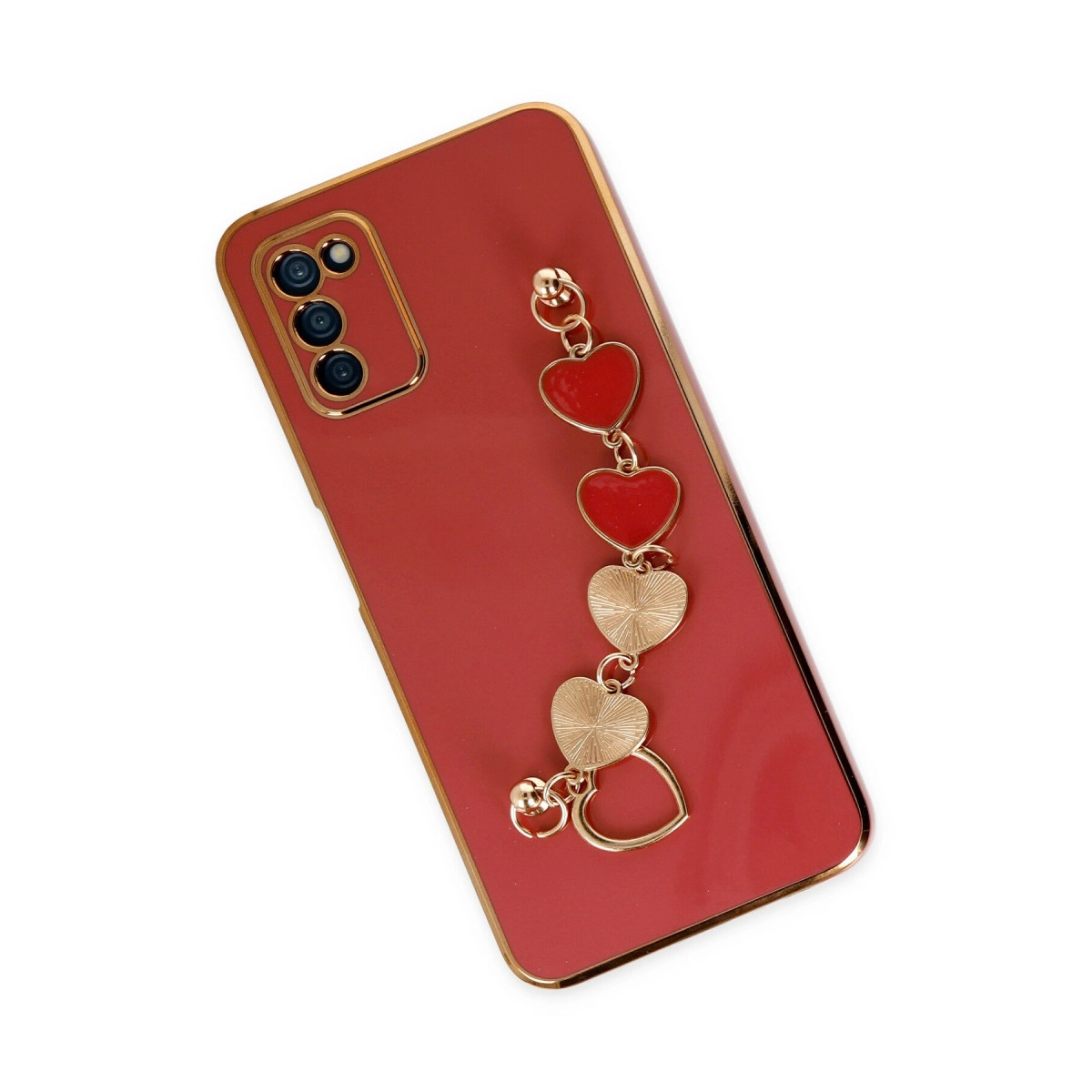 Altın kenarlı kırmızı telefon kılıfı ve kalp şeklinde takı.