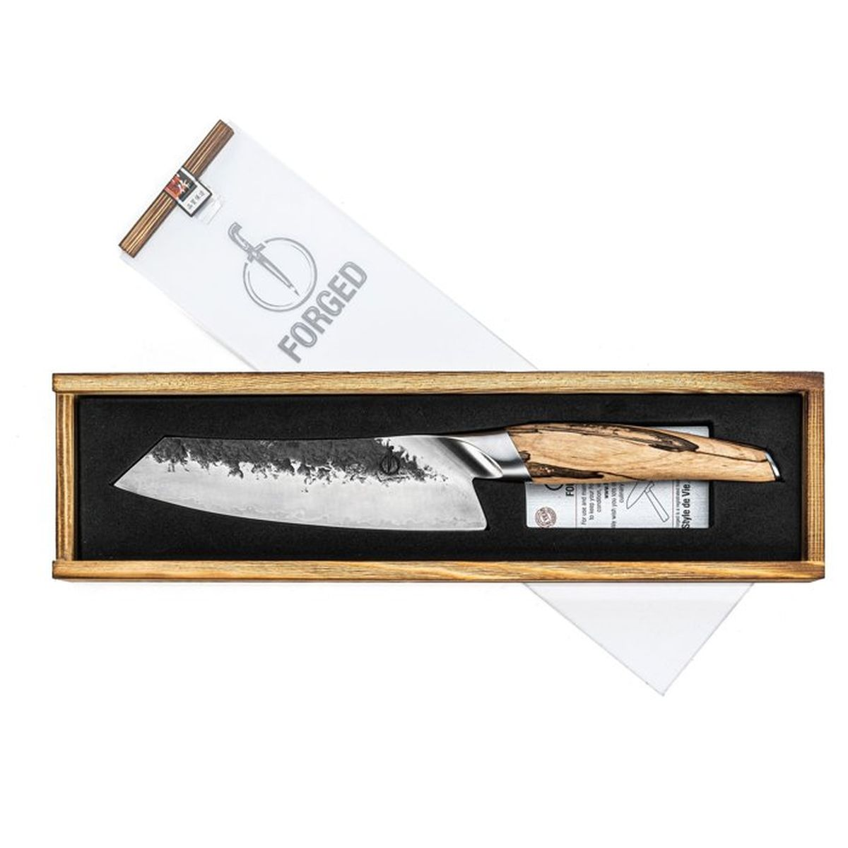 Un cuchillo de chef con mango de madera yace en una caja de madera con embalaje.