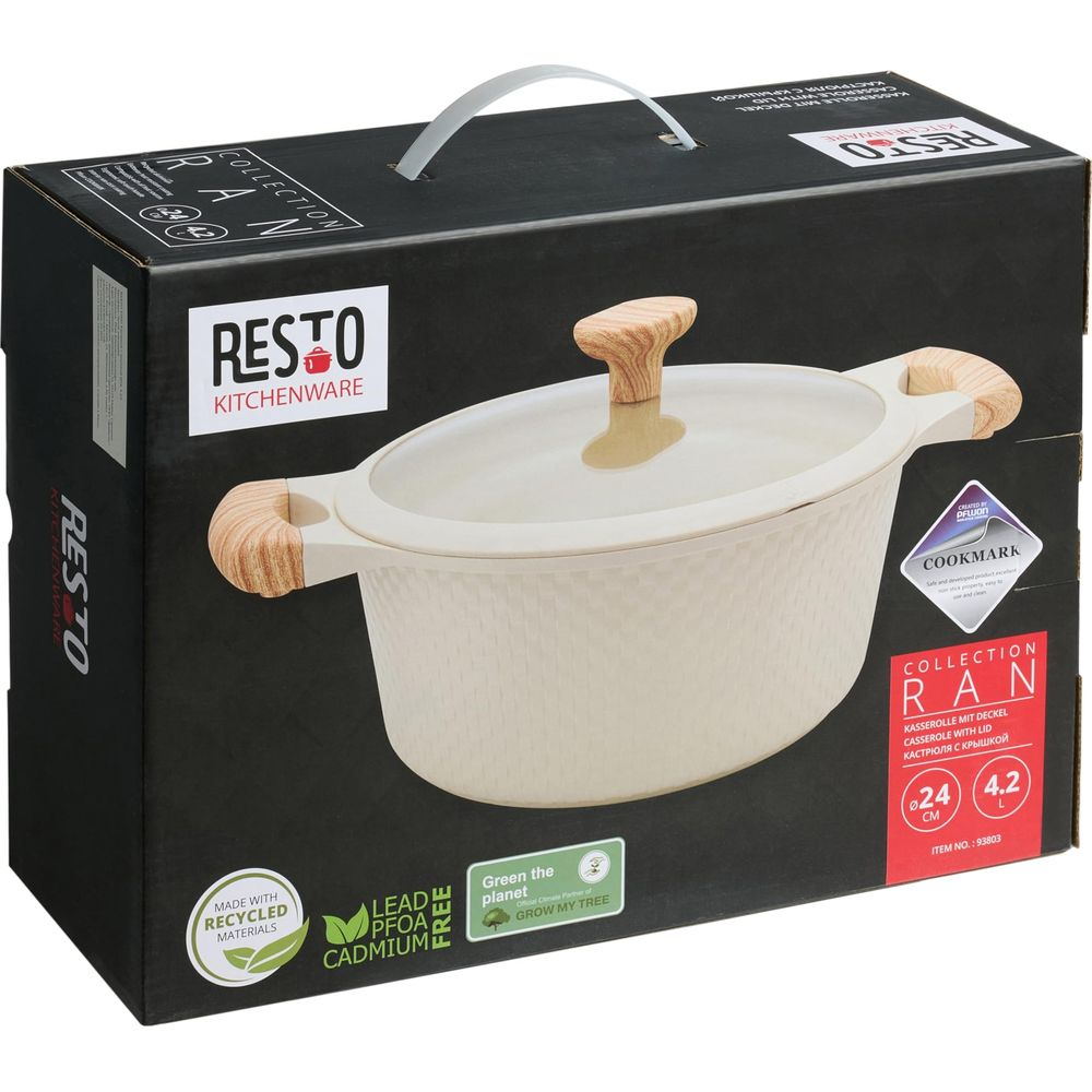 Une cocotte couleur crème avec poignées en bois et couvercle en verre sur boîte.