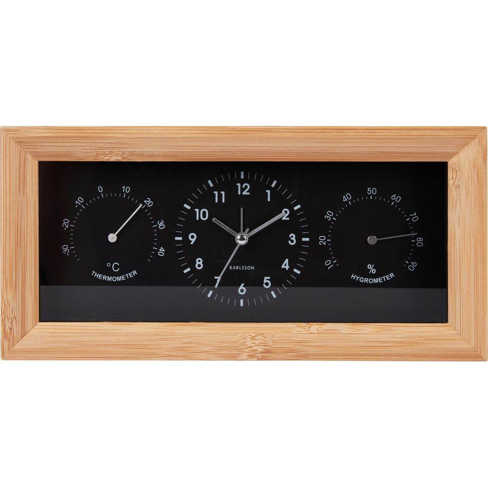Une horloge en bois avec thermomètre et hygromètre. Il est 1h47.
