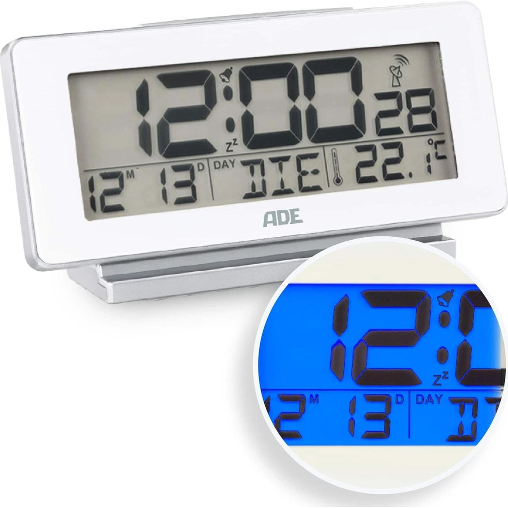 Réveil numérique avec boîtier argenté et écran LCD. Affiche l'heure, la date et la température.