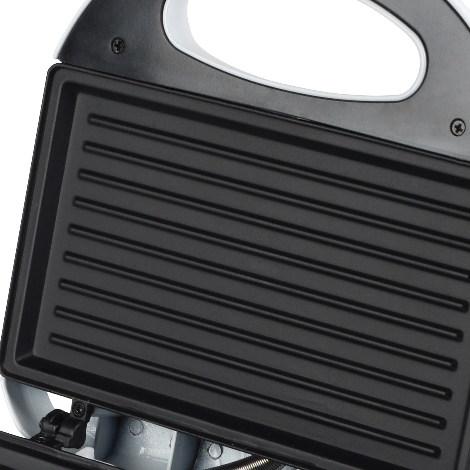 An open sandwich maker showing ribbed black heating plates and a white handle.